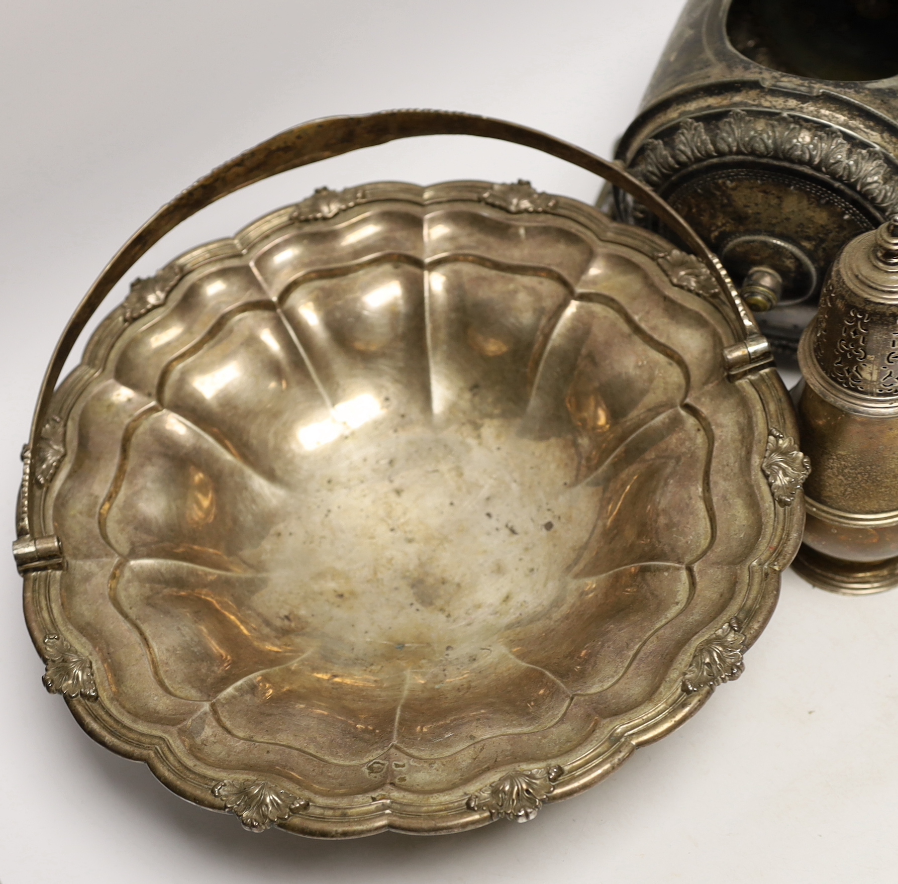 A George IV silver bread basket, London, 1827? (marks rubbed), diameter 31cm, together with a 1930's silver sugar caster, gross 40.2oz and a Brittania metal biscuit barrel.